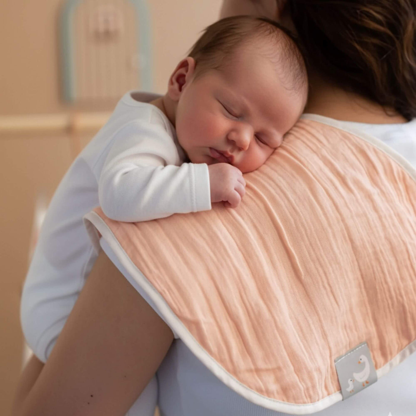 Pembe renkli omuz bezi kullanan anne ve bebek